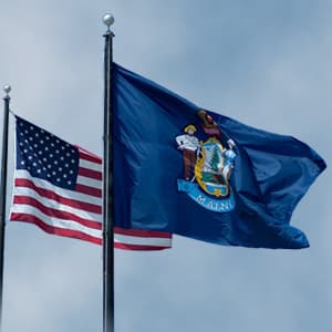 US and Maine flags